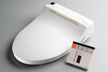 The Washlet is like an electronic bidet that sits on top of the toilet and has a control panel The Washlet is like an electronic bidet that sits on top of the toilet and has a control panel